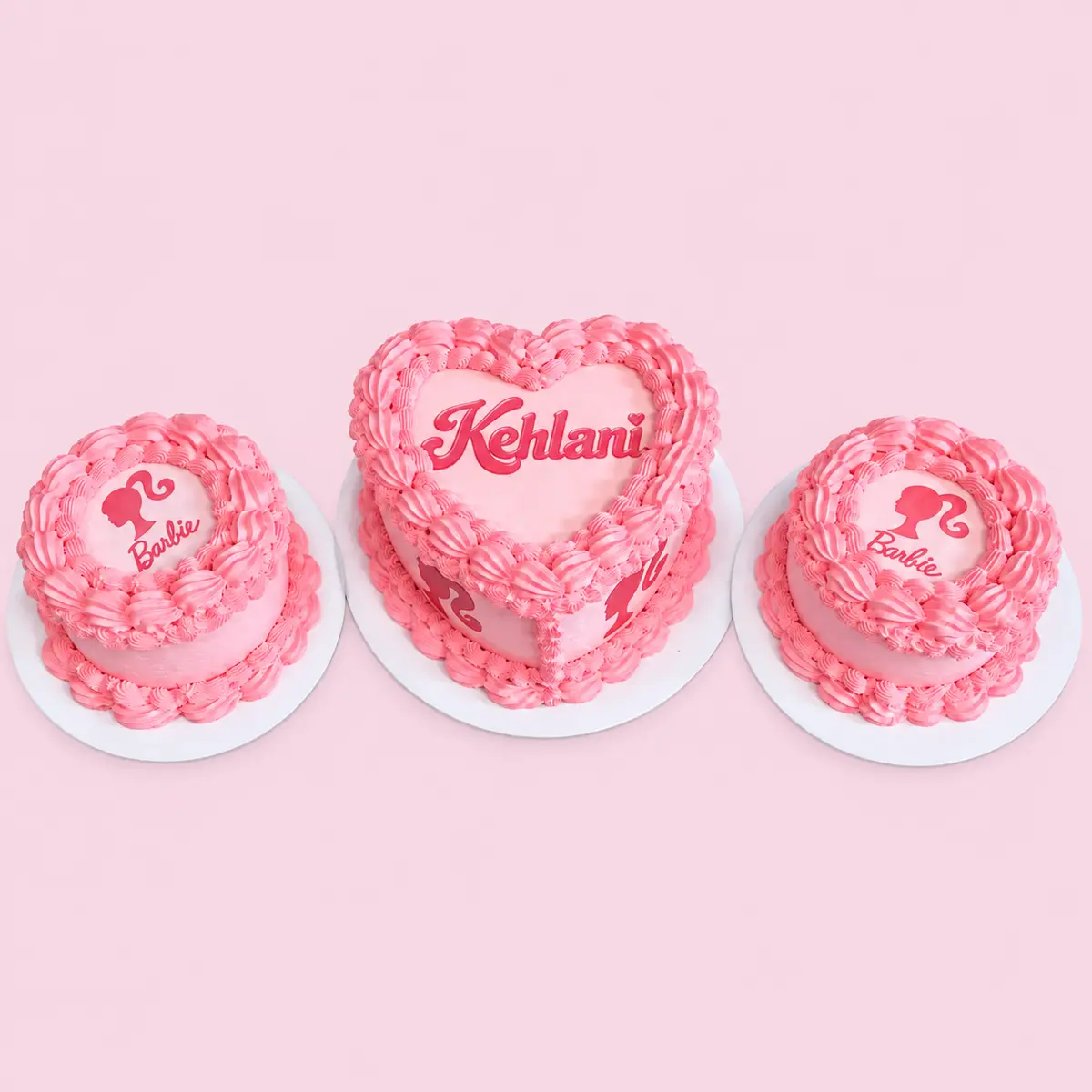 Three coordinated pink Barbie-themed celebration cakes