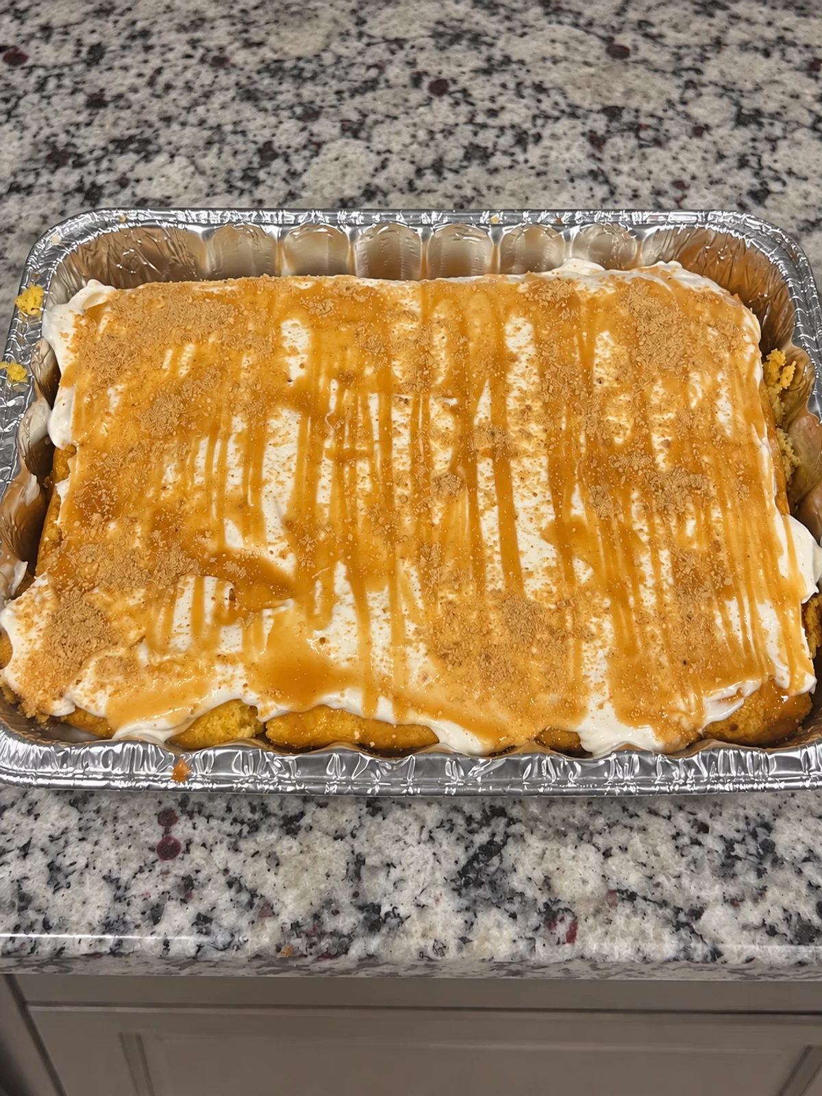 Homemade dessert in a foil tray with a drizzled topping