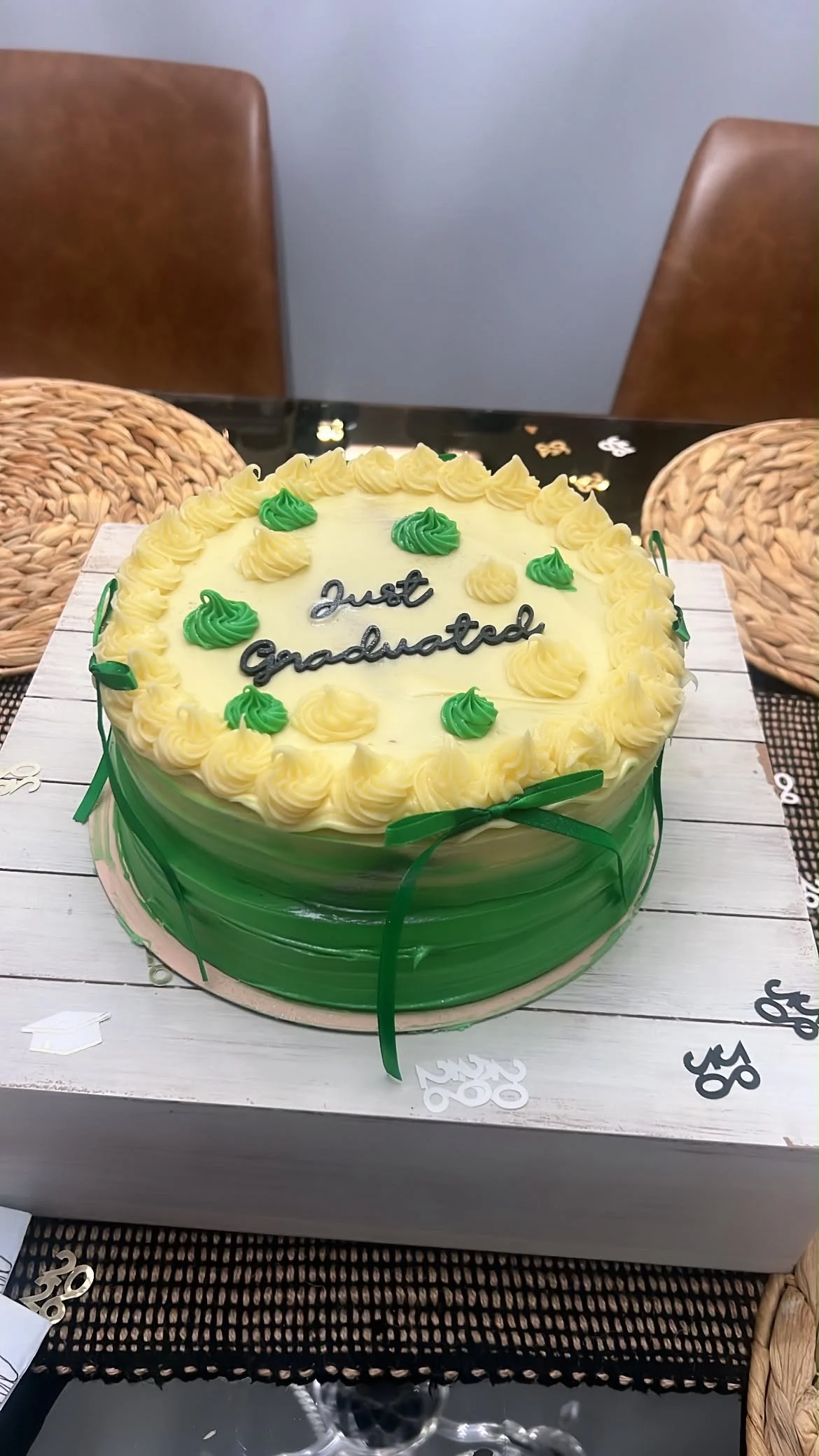 Green graduation cake with cream piping