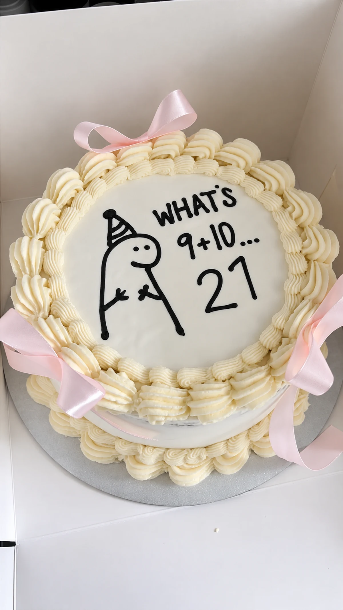 Cream 21st birthday cake with pink bows