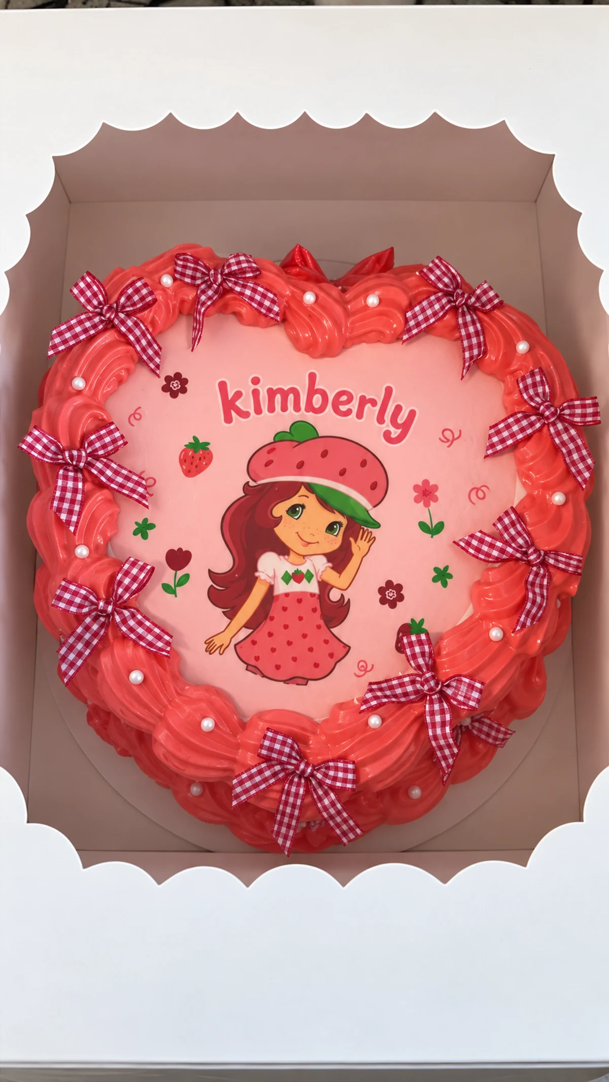 Pink and red strawberry-themed celebration cake